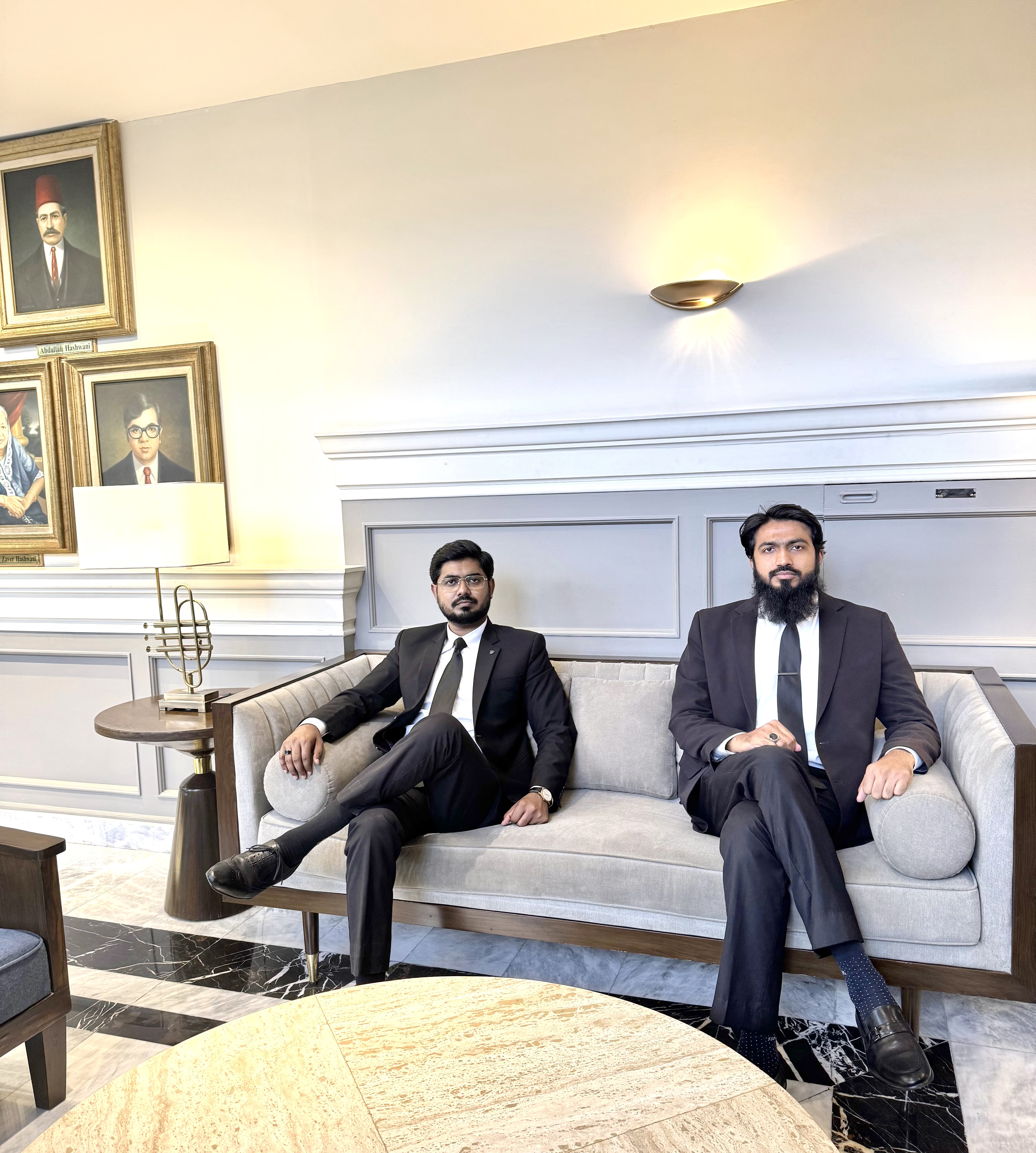 Naich Law Firm Partners sitting together in joint legal session